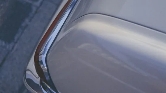 close detail of chrome delete work — film edge, texture or trim